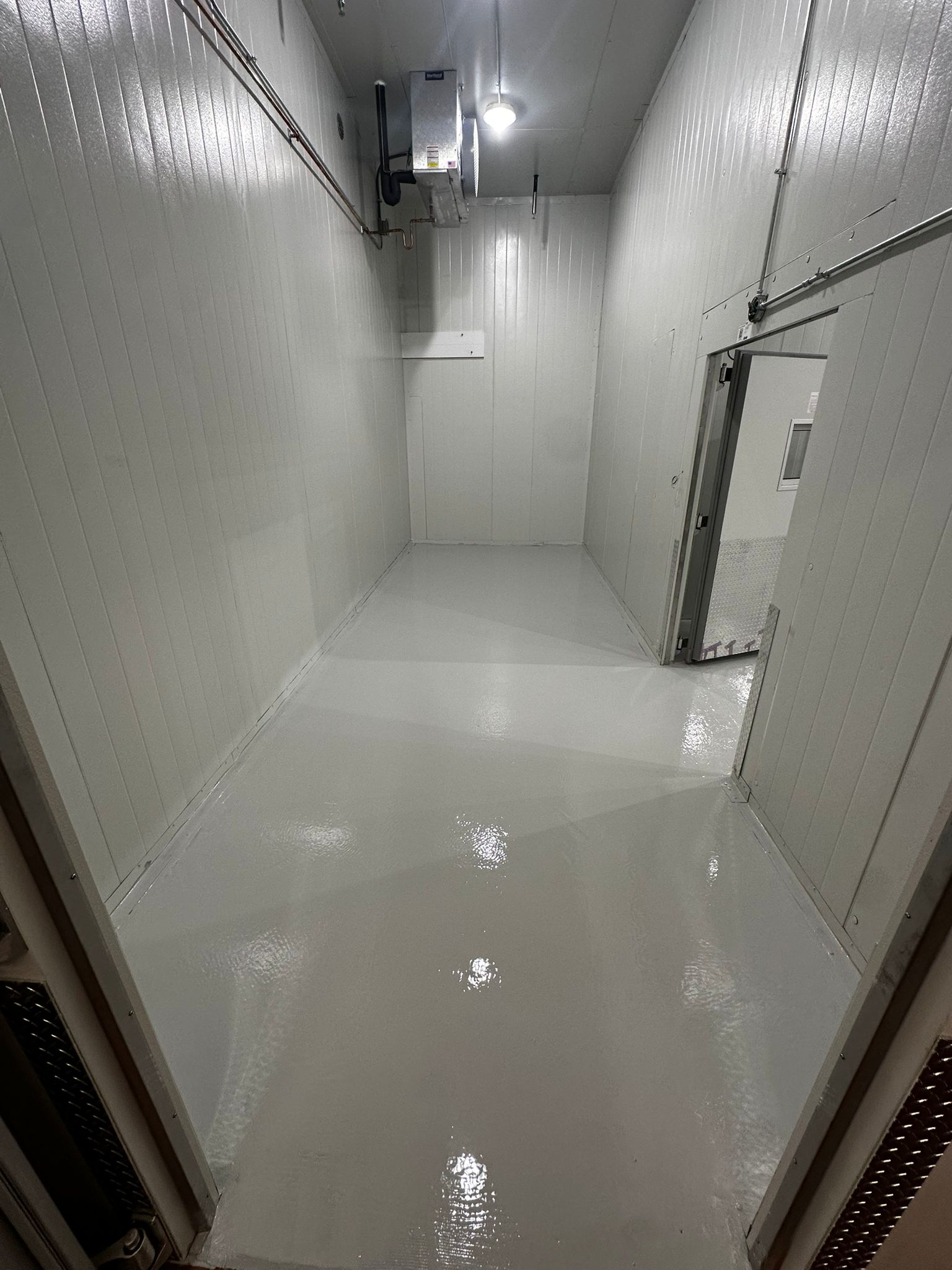 Storage area with smooth gray epoxy flooring and uniform finish